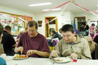 Brian and Zack enjoy a roast beef dinner at the 18th anniversary of the regular Wednesday Community Drop In at St. Andrew's Anglican church in Sharbot Lake that took place on October 15.